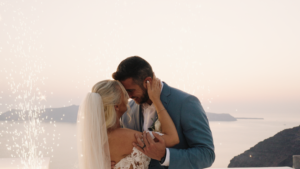 Jessica and Daniel during their Dana Villas wedding at sunset in Santorini